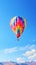 Vibrant Solitary Balloon Floating High in a Clear Blue Sky