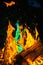 Vibrant Spectrum of Flames in Wood Fire at Night with Blue-Green Flare