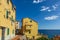 Vibrant streets of mediterranian town with deep blue sky and sea