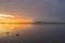 Vibrant sunrise sky and cloudscape reflected in calm lake waters