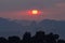 Vibrant sunset from Tiger Cave Temple (Wat Tham Suea) in Krabi, Thailand. Clouds around the sun looking like Saturn