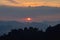 Vibrant sunset from Tiger Cave Temple (Wat Tham Suea) in Krabi, Thailand. Clouds around the sun looking like Saturn