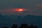 Vibrant sunset from Tiger Cave Temple (Wat Tham Suea) in Krabi, Thailand. Clouds around the sun looking like Saturn