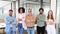 A vibrant team gathers around a minimalist white table in their bright office