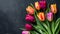 Vibrant Tulips on Dark Slate Background: A Colorful Spring Display