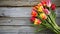 Vibrant Tulips on Rustic Wooden Background - Spring Floral Composition