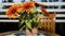 Vibrant Vase of Orange Flowers Resting on a Table