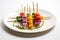 vibrant veggie skewers on a white plate, toothpicks by the side