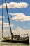 Vibrant vertical shot of a majestic sailboat sailing on a sparkling body of water