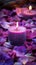 Vibrant violet candle amidst delicate pink and purple flower petals