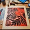 Vibrant Woodworking: Detailed Orange And Black Flower With Native Australian Motifs