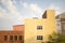 Vibrant yellow building stands in the warm Florida sunshine, surrounded by lush green foliage