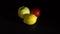 Vibrant Yellow Lemon, Ripe Apple, and Red Tomato Slowly Approaching on a Black Background