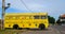 Vibrant yellow skin tourist bus parked on Galle fort, colorful drawings on the bus body
