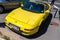 Vibrant yellow Toyota Celica sport car in good condition on the parking lot.