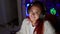 Vibrant young redhead woman streamer, all geared up in headphones, flashes a gaming victory with thumb up gesture in her home-