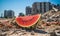 A vibrantly colored watermelon with a backdrop of shattered concrete and debris