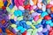 Vibrantly colorful candy pebbles spread evenly. Colorful background.
