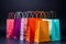 Vibrantly hued shopping bags stand out against a sleek black background