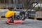 Vibrating plate compactor machine at a construction site. Equipment for soil thrombosis. Compaction work on sand, earth or asphalt