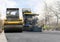 The vibratory roller levels the asphalt pavement