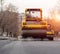 The vibratory roller levels the asphalt pavement