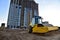 Vibro Roller Soil Compactor leveling ground at construction site. Vibration single-cylinder road roller on construction road. Road