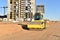 Vibro Roller Soil Compactor leveling soil at construction site. Excavator and vibration single-cylinder road roller during the