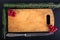 Viburnum berries on old worn out cutting board on the black back