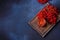 Viburnum fruit jam in a glass jar on a dark concrete background