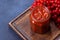 Viburnum fruit jam in a glass jar on a dark concrete background