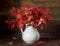 Viburnum with red leaves and berries behind a wet window