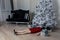 Victim of the New Year sales. A girl in a red dress lies under a Christmas tree littered with gifts. The holiday comes to us