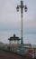 Victorian bandstand on the promenade in Brighton, East Sussex, UK, with lamp post in the foreground. Photographed at dusk