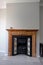 Victorian Black cast iron fireplace with tile trim in a wooden pine surround and a marble hearth