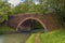 A Victorian brick-built bridge spans the Grand Union Canal near Wistow, UK