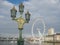 Victorian and classical lamppost detailed with London Eye on background