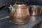 Victorian copper casserole pan on a black antique gas stove in a
