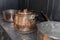 Victorian copper casserole pan on a black antique gas stove in a