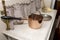 Victorian copper saucepan in a Victorian kitchen setting on a white wood chest of drawers