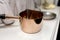 Victorian copper saucepan in a Victorian kitchen setting on a white wood chest of drawers