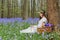 Victorian girl in bluebells forest