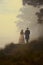 victorian historical couple walking in love down a foggy path.