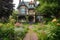 victorian house with lush garden, blooming flowers and stone pathway