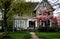 Victorian house with ornamental trees.