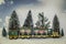 Victorian model train with passengers and luggage on top chugs through snowy forest - Close-up detail of Christmas village