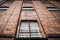 Victorian old red brick prison jail with bars over cell windows of high security run down immigration detention centre in England