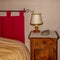 Victorian style decorated bed and side table with bible