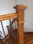 Victorian style staircase wood newel post haindrail brown metal baluster close-up