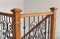 Victorian style staircase wood newel post haindrail brown metal baluster close-up